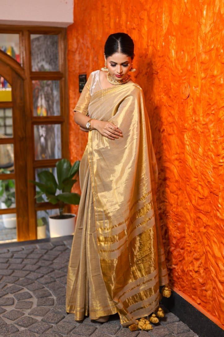 SAREEN Golden Beige Raga Tissue Saree with Subtle Zari Stripes & Tassel Pallu